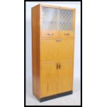A retro 1950's oak veneer Pride-O-Home kitchen dresser cabinet comprising a series of cupboards