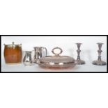 A collection of silver plated items to include a pair of Victorian silver plated copper candlesticks