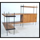 A vintage retro 20th century teak wood ladderax style corner shelving unit having a series of