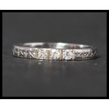 An 18ct white gold and diamond band ring set with three old cut diamonds in a star cut band.