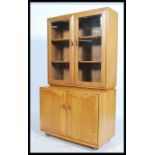 Ercol - Windsor - A retro beech and elm sideboard display cabinet comprising of a glazed twin door