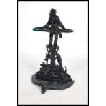 A 20th century cast metal stick stand in the manner of Coalbrookdale having an ebonsied finish
