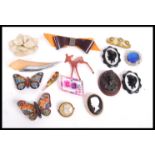 A collection of vintage and earlier brooches including Bakelite, Lucite, reversed carved, sculpted