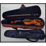 A 20th century students cased Stentor Student II violin together with a mother of pear inlaid bow.