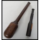 Two vintage 20th century turned lignum wood fishing priests of turned form. Measures 35 cm long.