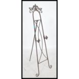 An oversized decorative scroll work folding easel picture / artists stand, having the ability to