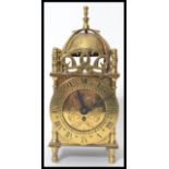 A Smiths Brass eight day XVII Century style lantern clock, bell with finial over a circular dial,