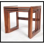 A retro 1970's teak wood nest of tables in the Danish manner. The tables of square form with