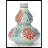 A Chinese celadon gourd shade snuff bottle - perfume bottle decorated with character marks and