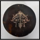 An early 20th century tortoiseshell and silver inlay box of circular form having silver hallmarked