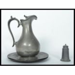 A group of 19th century Georgian pewter wares to include a water jug a pair of circular plates and a