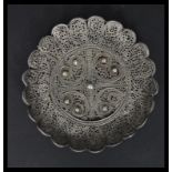 A 19th century Indian / Islamic Silver filigree dish having a scrolled central medallion with