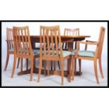 G-Plan - A 20th century teak wood dining room suite comprising of an oval dining table with a fold