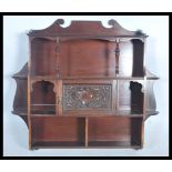 A  Victorian mahogany hanging wall cabinet. The shelves of multiple sections with gallery back