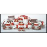 A 20th century Noritake tea service having a red banded border with gilt decoration comprising cups,
