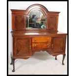 A 1930's mahogany mirror back sideboard having an arrangement of drawers and cupboards being