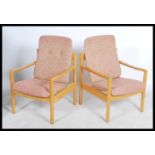 A pair of 20th century Ercol staff chairs. Light b