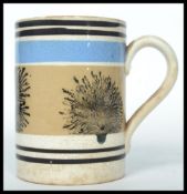 A 19th century Mocha ware tankard having a white g