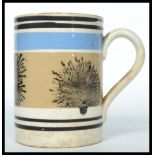 A 19th century Mocha ware tankard having a white g