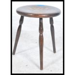 An early 20th century stained beech tripod stool h