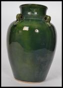 An early 20th century tall vase / water carrier in