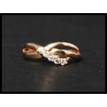 An 18ct gold and white stone ring set with five wh