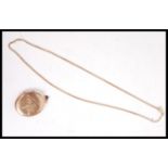 A 9t gold box lined necklace chain and large oval