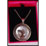 A silver Essex crystal necklace pendant depicting