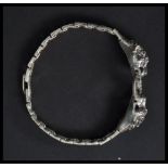 A sterling silver bracelet in the form of two pant