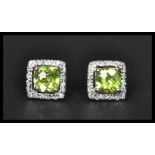 A pair of sterling silver and CZ stud earrings of