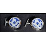 A pair of sterling silver an enamel cuff links set with masonic symbols. Weighs 9 grams.