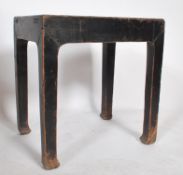 A believed early 20th century Chinese opium stool in elm wood having an ebonised painted and