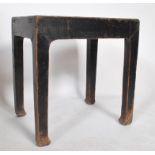 A believed early 20th century Chinese opium stool in elm wood having an ebonised painted and