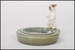 An early 20th century Royal Doulton ceramic figurine ashtray featuring a Sealyham Terrier in a