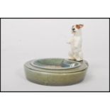An early 20th century Royal Doulton ceramic figurine ashtray featuring a Sealyham Terrier in a