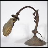 A 19th century Art Nouveau desk / wall light of cast metal construction. Raised on a beaded circular