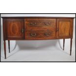 An Edwardian mahogany inlaid bow fronted sideboard by Maple & Co. Raised on squared tapering legs