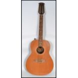 A vintage 20th century Encore 12 string guitar. The twelve strings having mother of pearl tuning