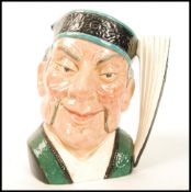 A Royal Doulton character jug entitled ' The Mikado ' D6501 , handle modelled after a hand fan.