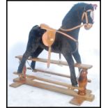A good quality Mamas and Papas child's rocking horse on wooden base with ribbon award for the pony