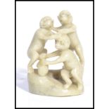 A Chinese unusual carved one piece soapstone jade coloured diorama carving of three monkeys on