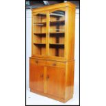 A mid 20th century Air Ministry style oak library bookcase cupboard. The base with drawers and
