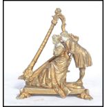 A 19th century parian ware gilded figure group of a courting lady and gent next to a harp. Raised on