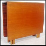 G plan - A 1970's teak wood drop leaf dining table raised on pierced legs with a scissor gate leg