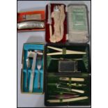 A 19th century cased vanity necessaire set having various needles picks glove stretcher etc along