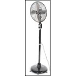 A large vintage retro 20th century industrial floor standing fan having steel blades and makers