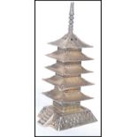 A Chinese silver pepperpot pepperette in the form of a Pagoda building. Stamped 925. Weighs 30.5