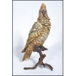 A vintage 20th century cold painted Austrian bronze figurine of a parrot resting on a branch