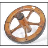 A large vintage 20th century wooden and cast metal pulley wheel.