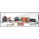 A collection of vintage cameras to include a Zeiss Ikon Contina, a vintage Eumig Servomatic and an
